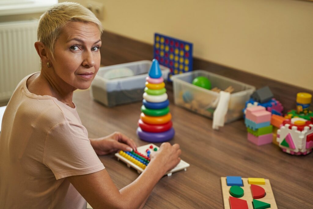 Caucasian woman performing occupational therapy in medical center