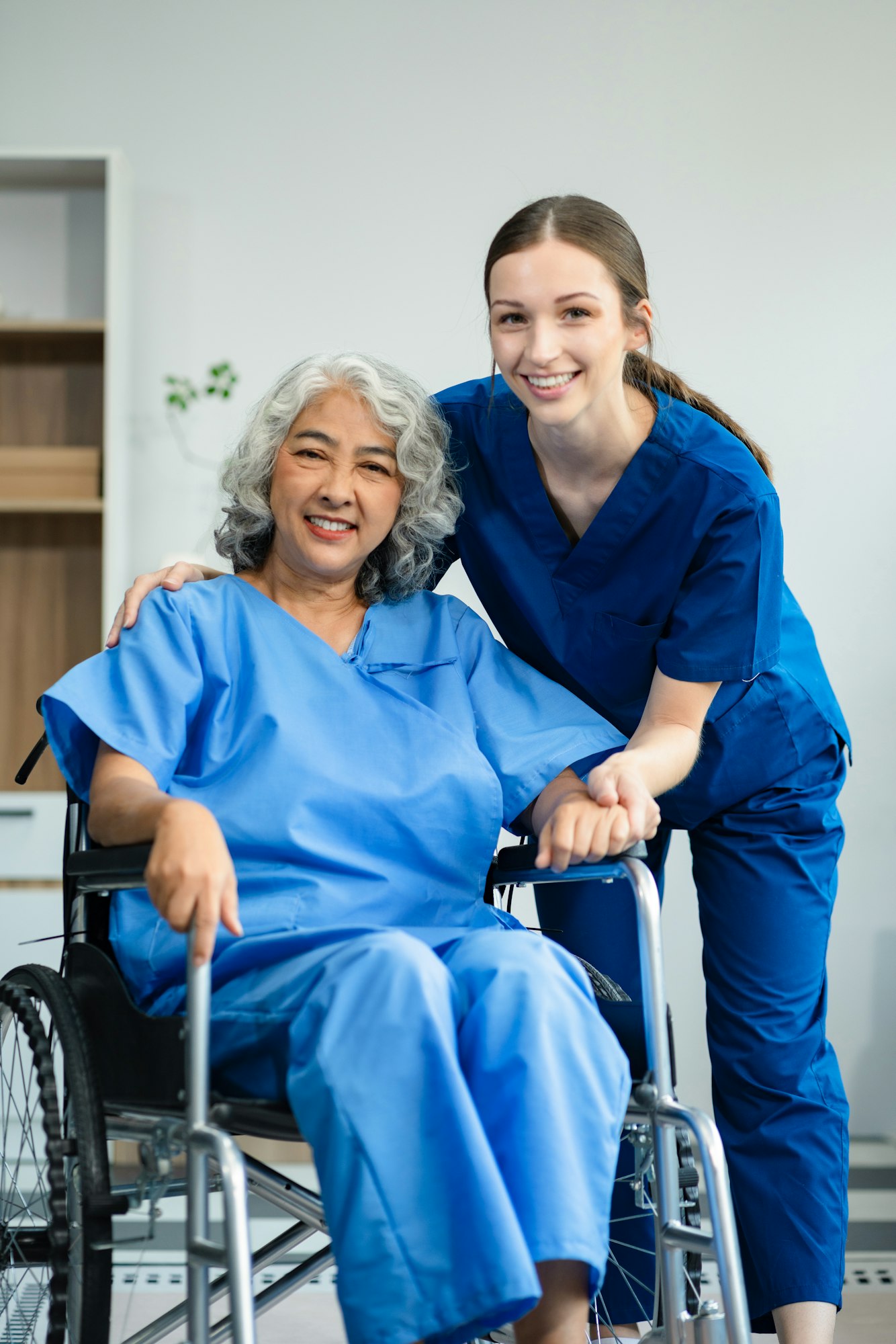 Elderly care concept. Portrait of nurse and her senior client on wheelchair.